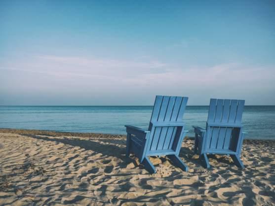 beach with two blue chairs