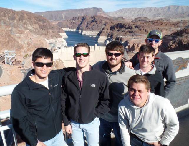 Picture of six CIM students posing at the Hoover Dam in Las Vegas