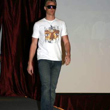 Student wearing a print tee-shirt, jeans and sunglasses.