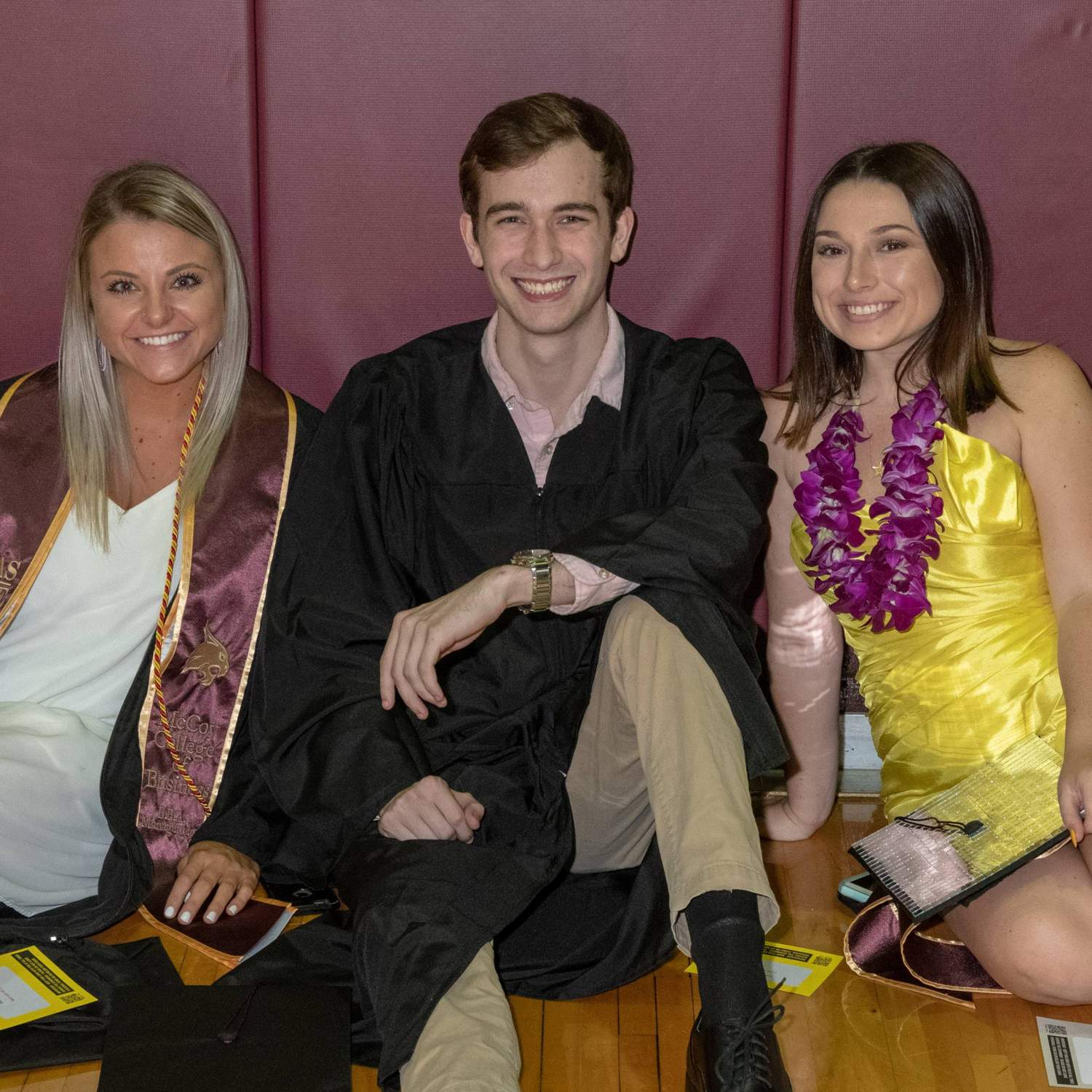 Three graduates smiling