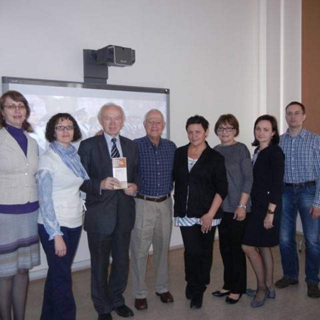 Kaunas Technological University (KTU) faculty, including current Department Chair Rasa Snapstiene and former Department Chair Vladas Domarkas with Dr. Howard Balanoff in Kaunas Lithuania. Professor Domarkas is holding a Texas CPM Brochure in his hand.
