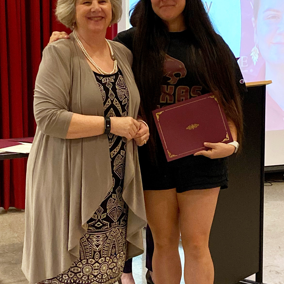 Student receiving an award from faculty