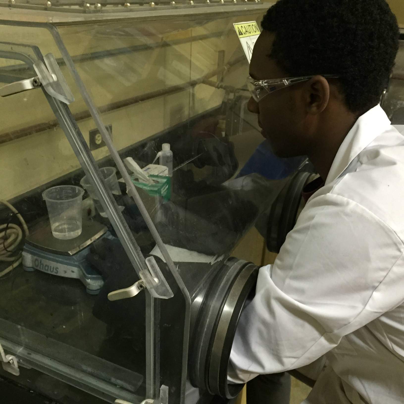 Daniel Slaughter working with nano-particles in a specialized glove box.