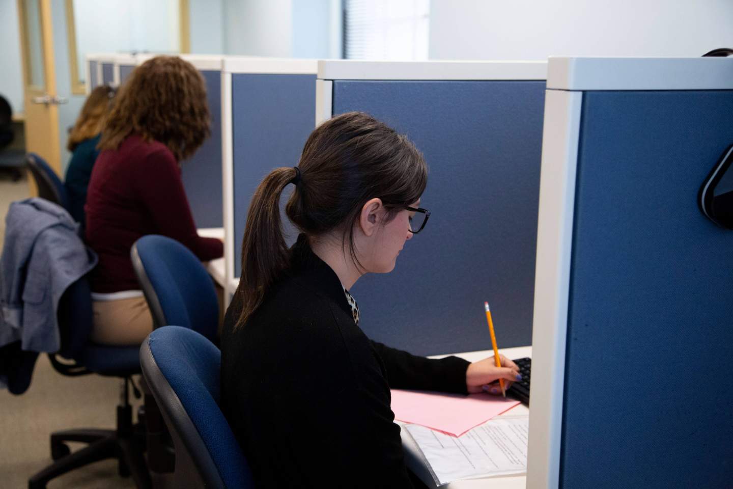 Student taking a test in a cubicle
