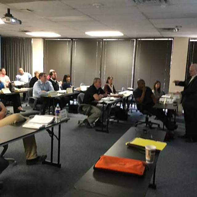 Mr. Chris Hartung, Owner & President of Hartung Consulting (front of room) provides information on recruiting and selection of employees to participants in the Texas CPM Program in Arlington, Texas.