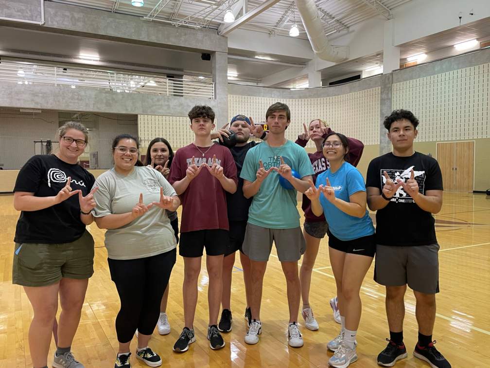 Student organization members taking a group photo at their dodgeball intramural game.