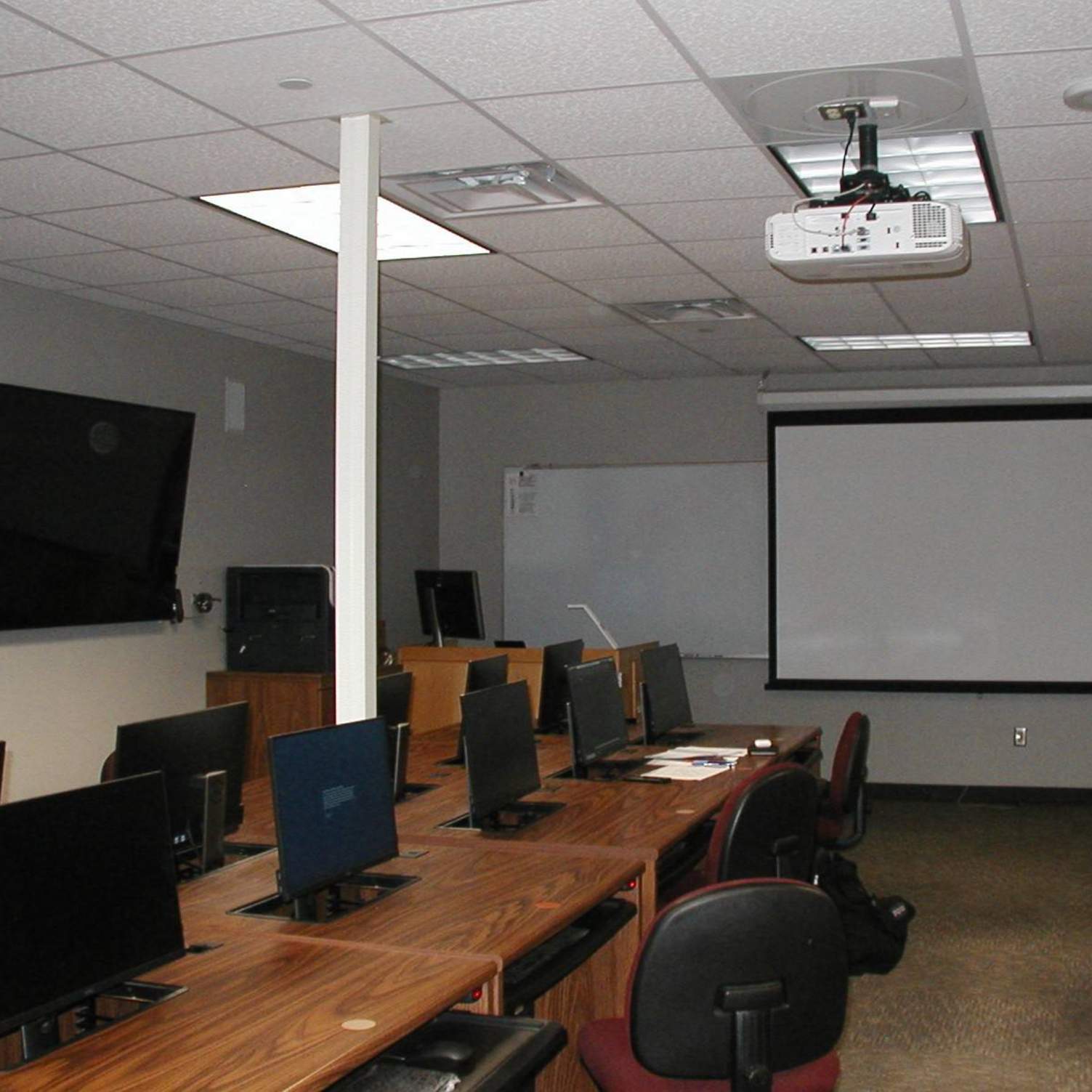 Front of classroom with projector screen.