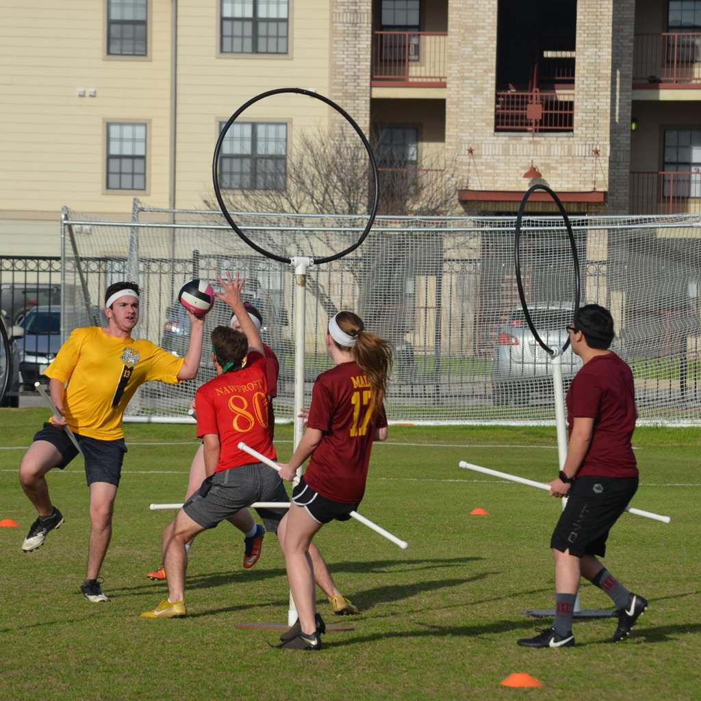 Quidditch players defending hoop.