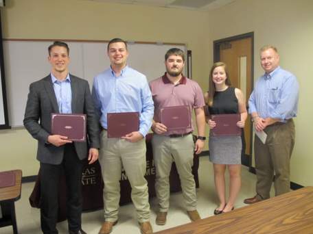 An image of four CIM students and Dr. Wilde after receiving their scholarship award.
