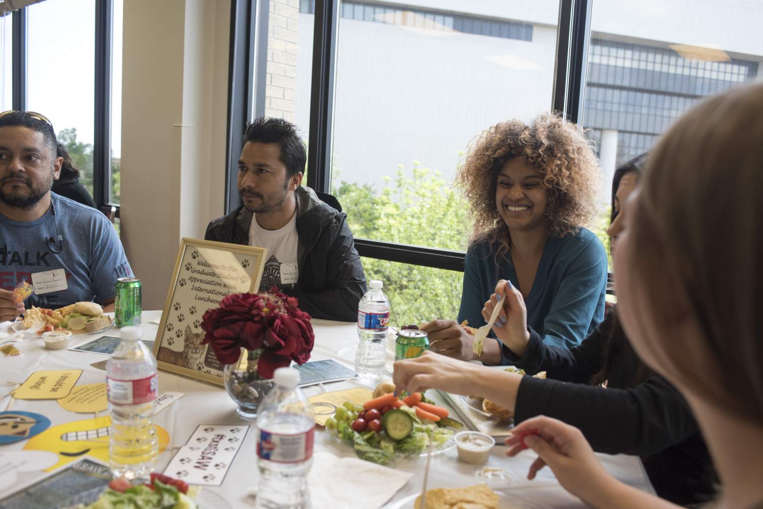 a group of students share a table and conversation during an event luncheon