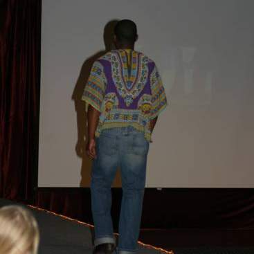 Student wearing bright printed topand jeans.