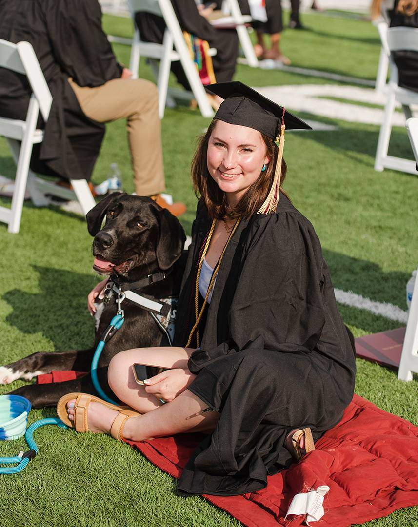 female graduate with dog