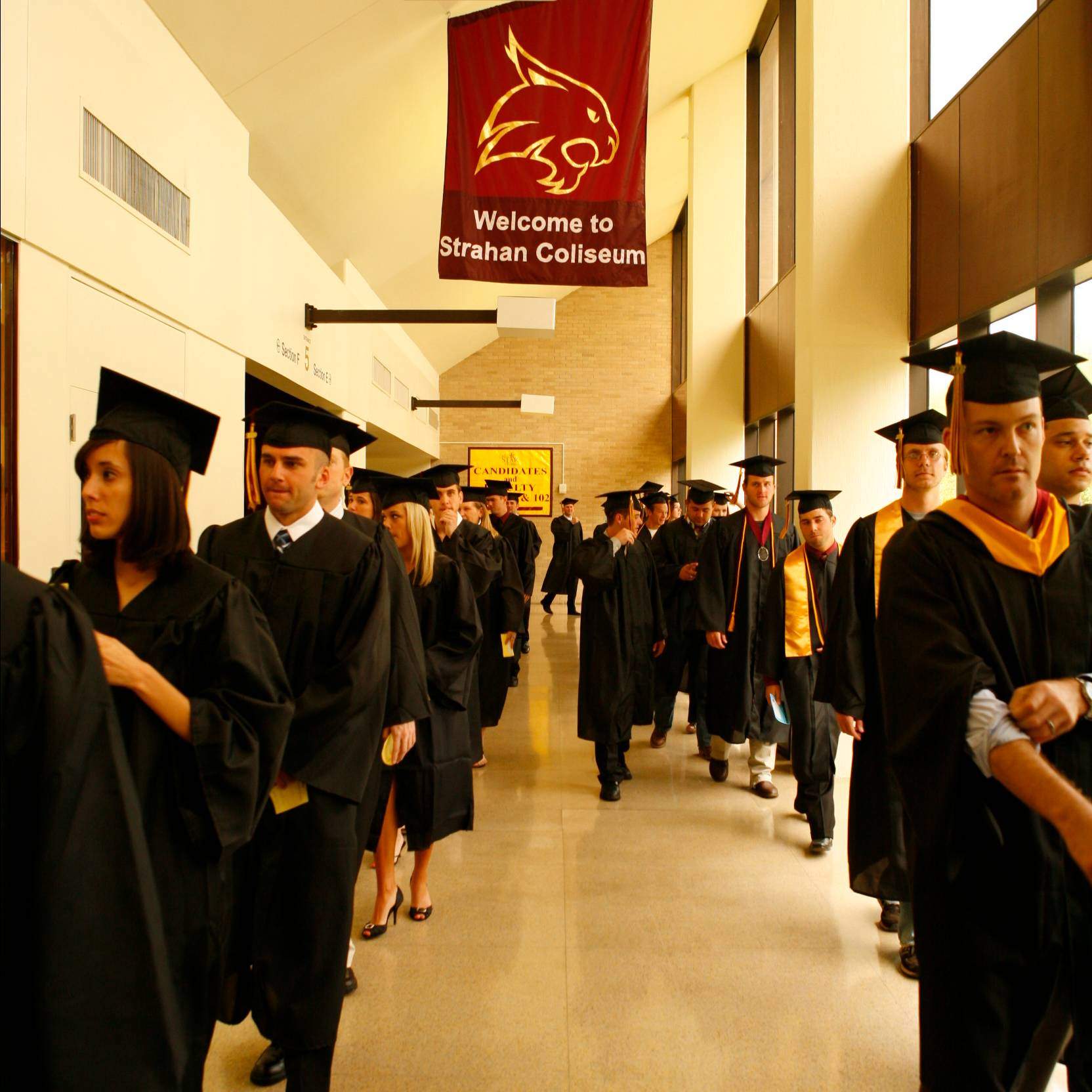 Graduating seniors walk through Strahan Coliseum