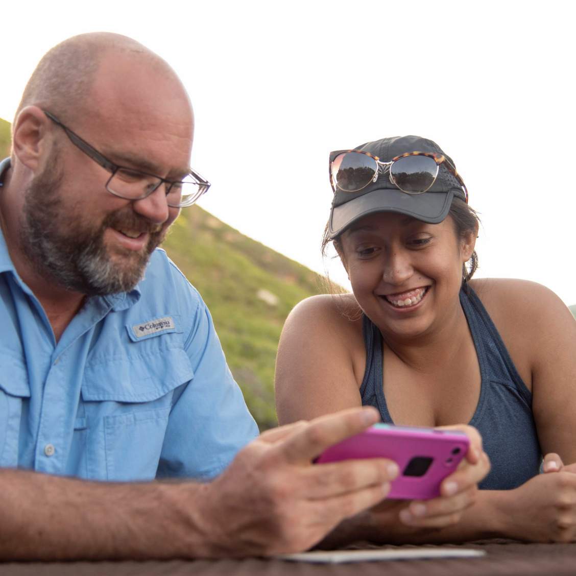 Student and professor sit together, reviewing images on a phone