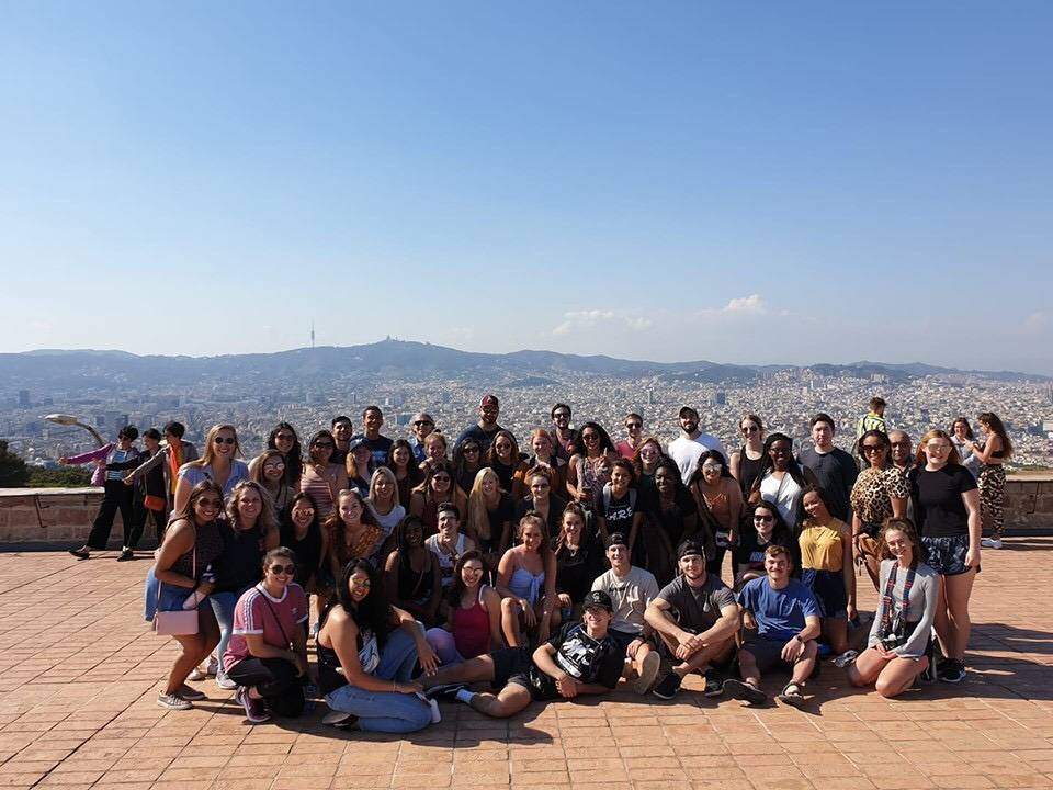 Group of students posing in front of large landscape in Barcelona, Spain