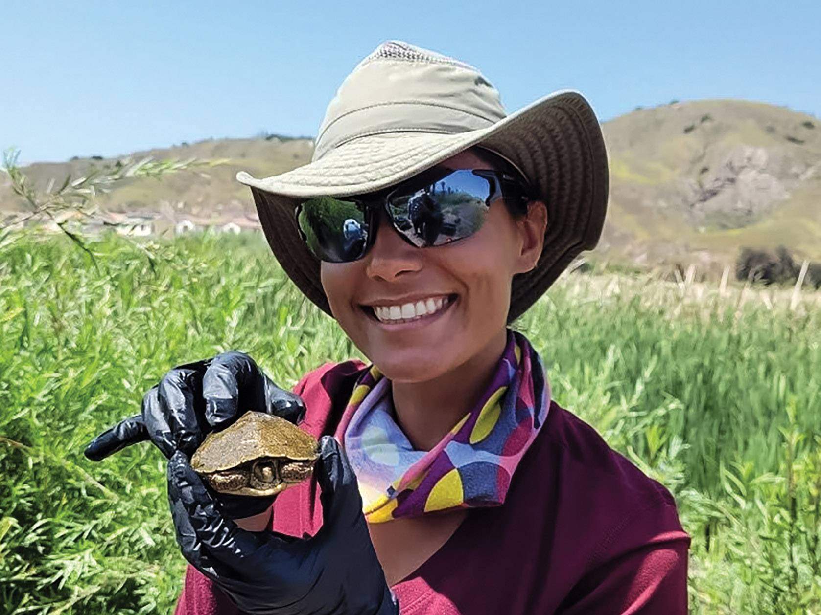 woman holding a small turtle