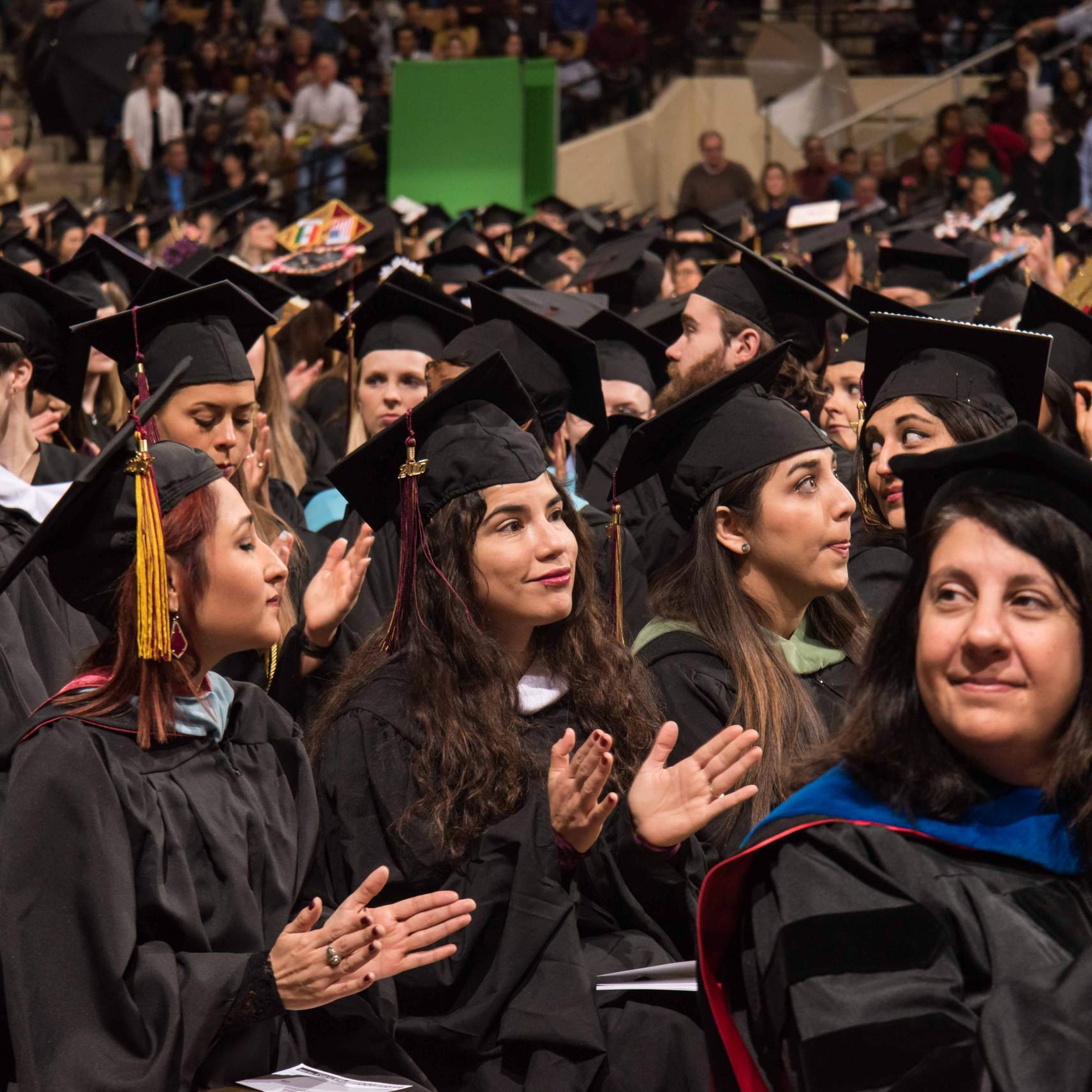 Graduates clapping during the ceremony.