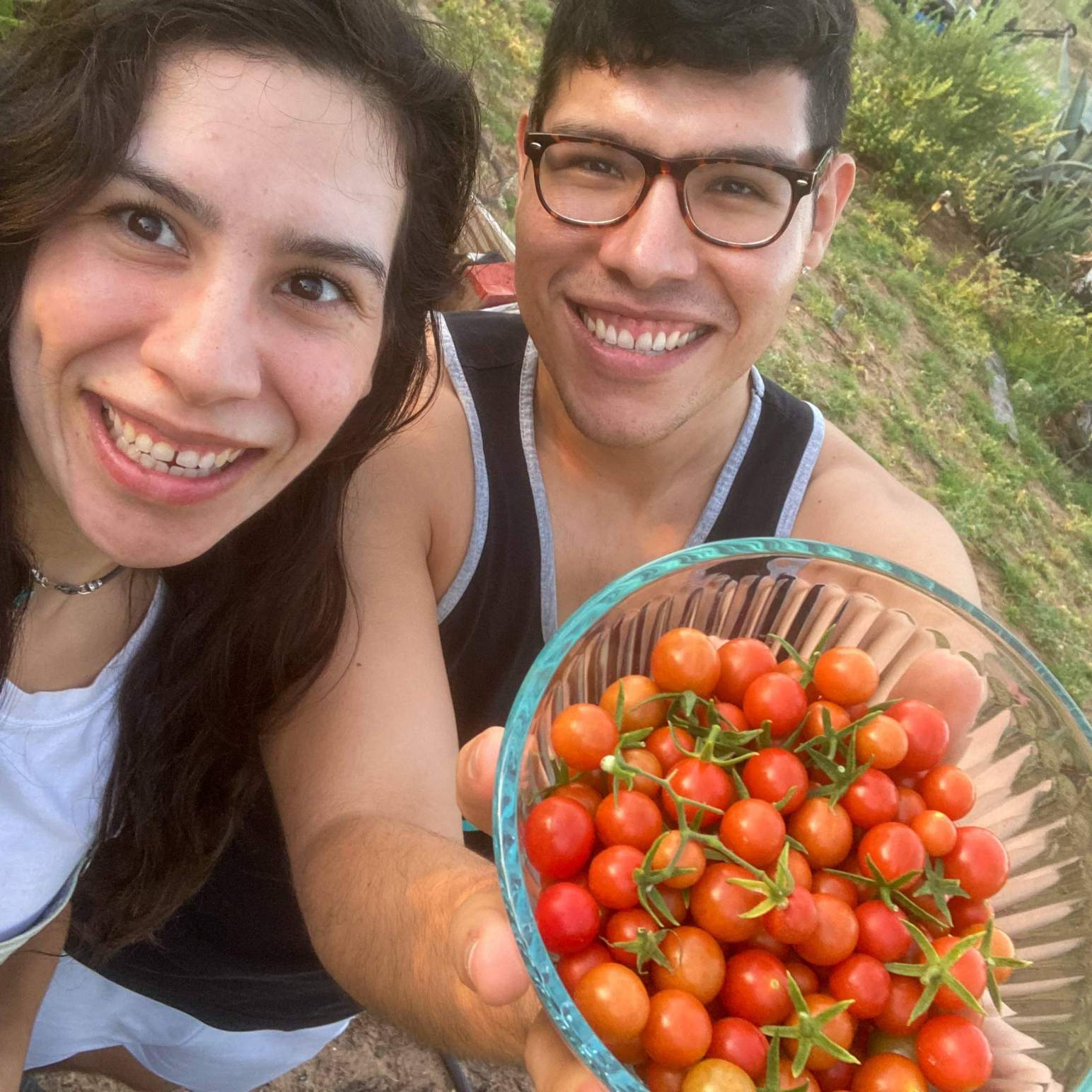 marcella and man holding tomatoes