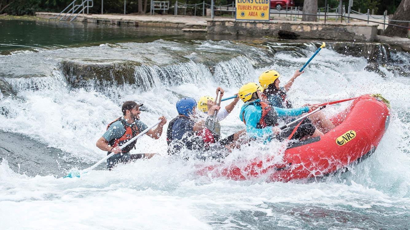 rafters in the San Marcos river rapids 