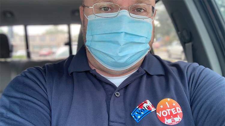 man wearing a vote campaign sticker.