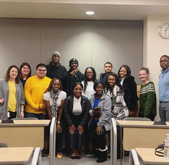 group of 14 NABA students with EY representatives