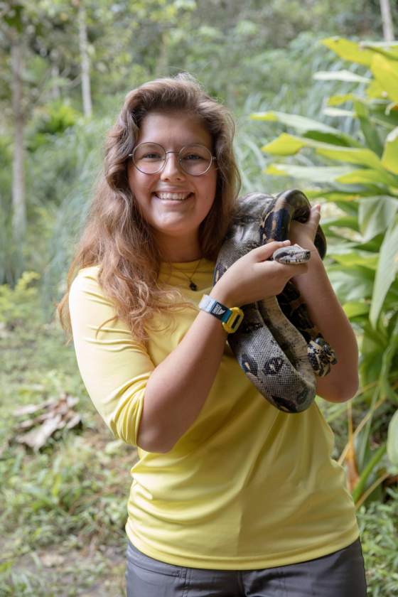 student Bianca Gebhardt holds a boa constrictor