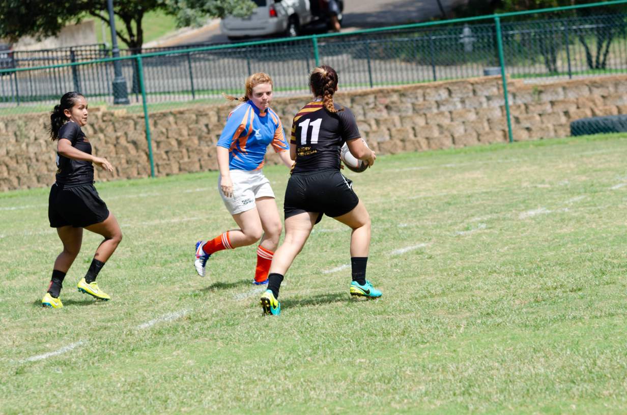 Women's Rugby player running with the ball