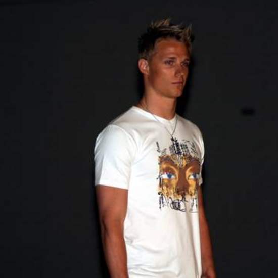 Student wearing a print tee-shirt with a face design on it.