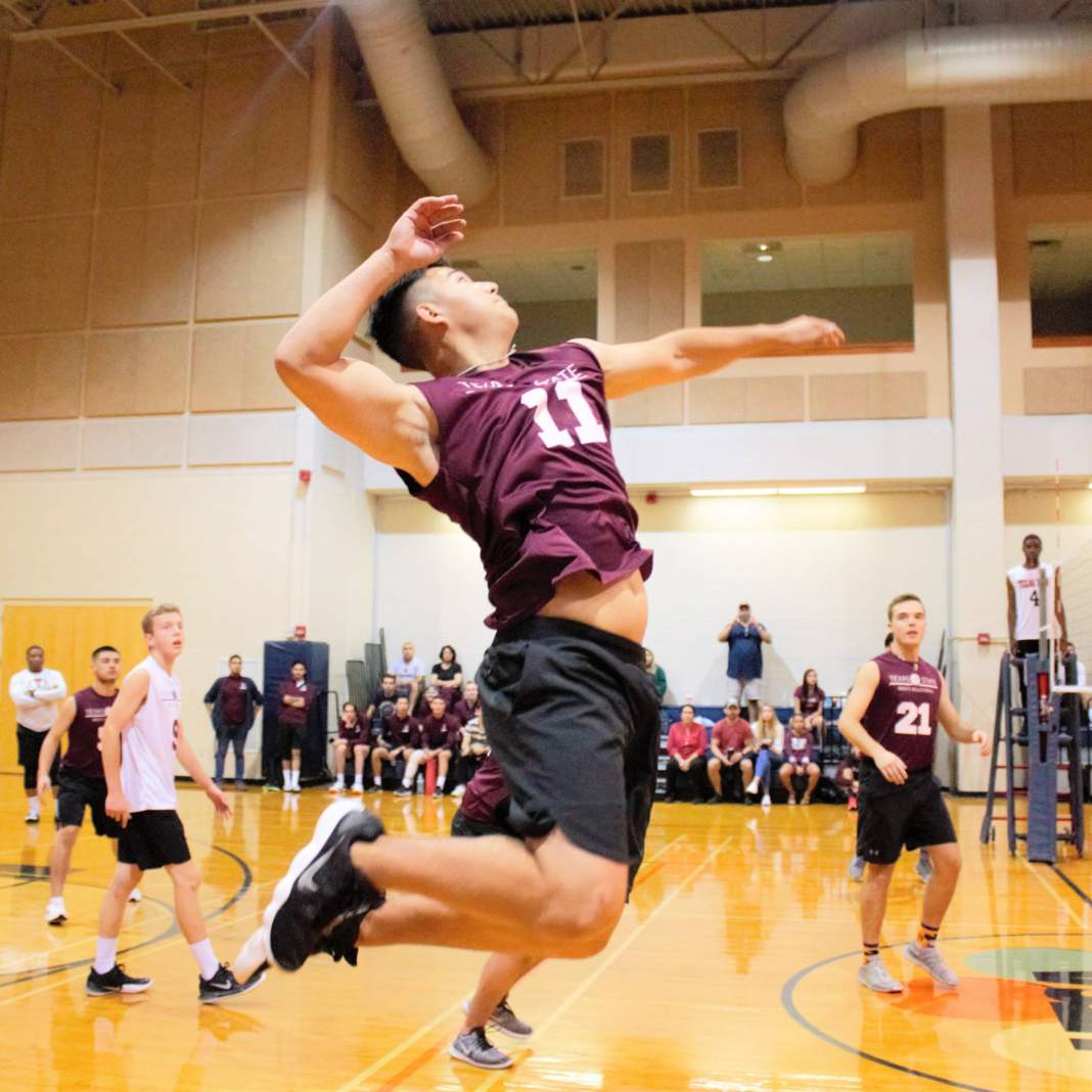 Men's Volleyball attempts a spike 5