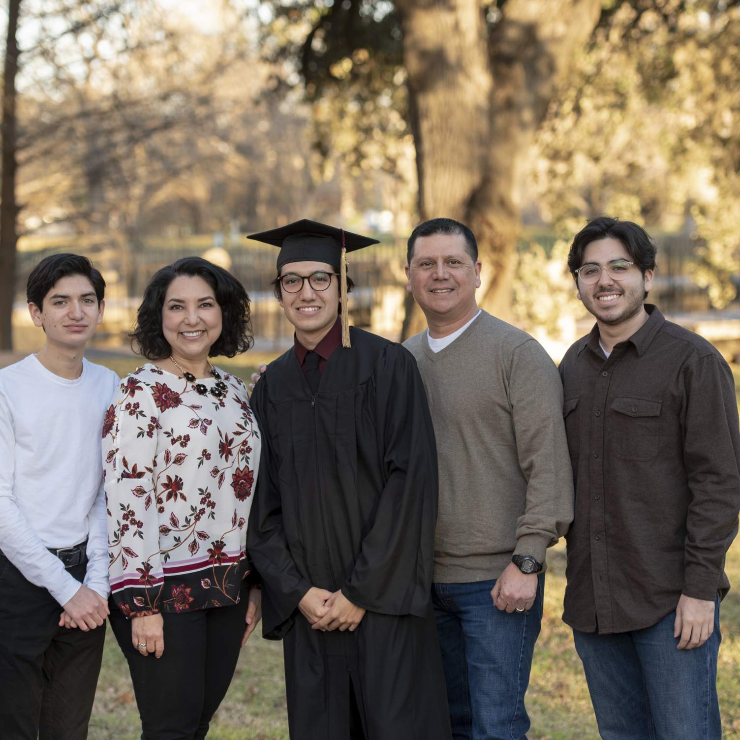 graduate and their family smiling in Sewell Park