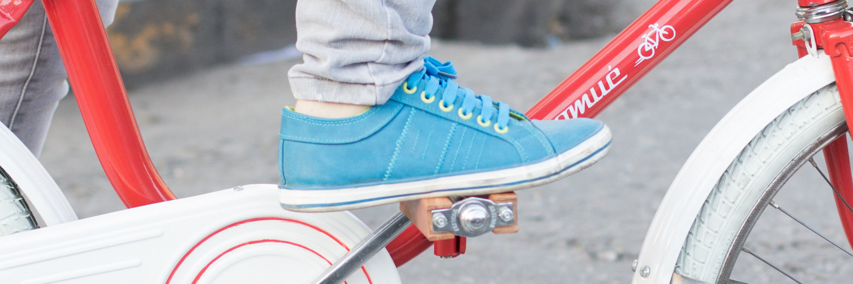 Foot in a blue sneaker on a bike pedal