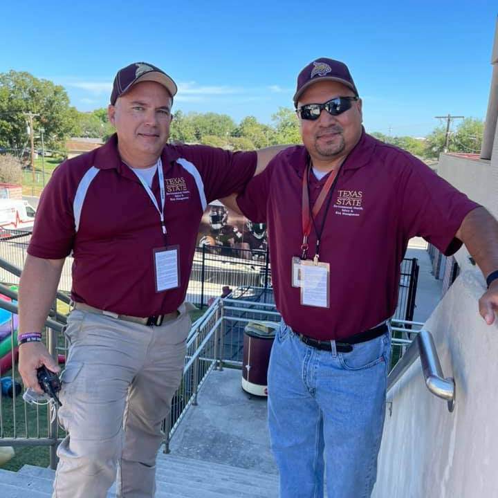 Emergency Manager and Emergency Technician standing on stairs at football game
