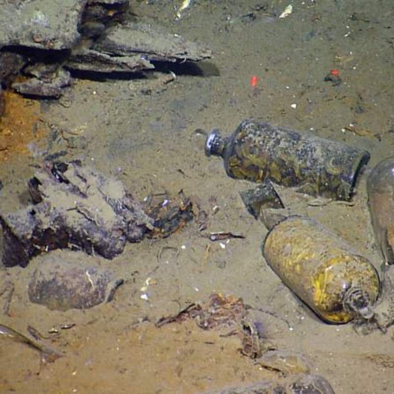 Medicine bottles, still filled with their contents, lie in what once was the wardroom and officer’s cabins in the wreckage of an early 19th century shipwreck recently documented and partially excavated in the Gulf of Mexico in more than 4,300 feet of water.  The wreck is one of three sites investigated by scientists from the Bureau of Ocean Energy Management, the National Oceanic and Atmospheric Administration, the Bureau of Safety and Environmental Enforcement, the Texas Historical Commission, and the Meadows Center for Water and the Environment at Texas State University.  The project was funded by donations and sponsorships arranged by the Meadows Center, and conducted in partnership with the Ocean Exploration Trust at the University of Rhode Island on board the Exploration Vessel Nautilus. (Ocean Exploration Trust/Meadows Center for Water and the Environment, Texas State)