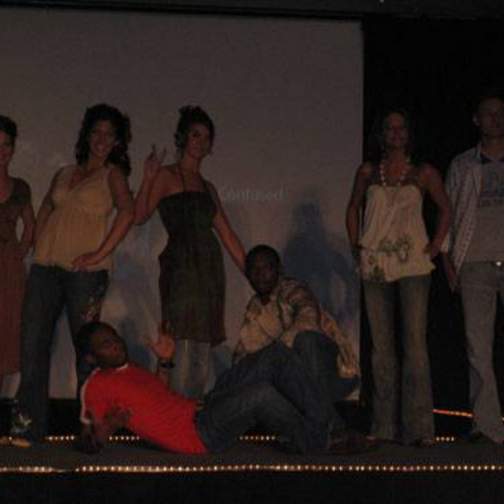 Group of male and female student/models on the stage at the fashion show.