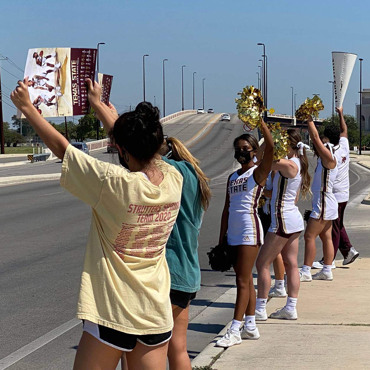 cheer leaders holding signs
