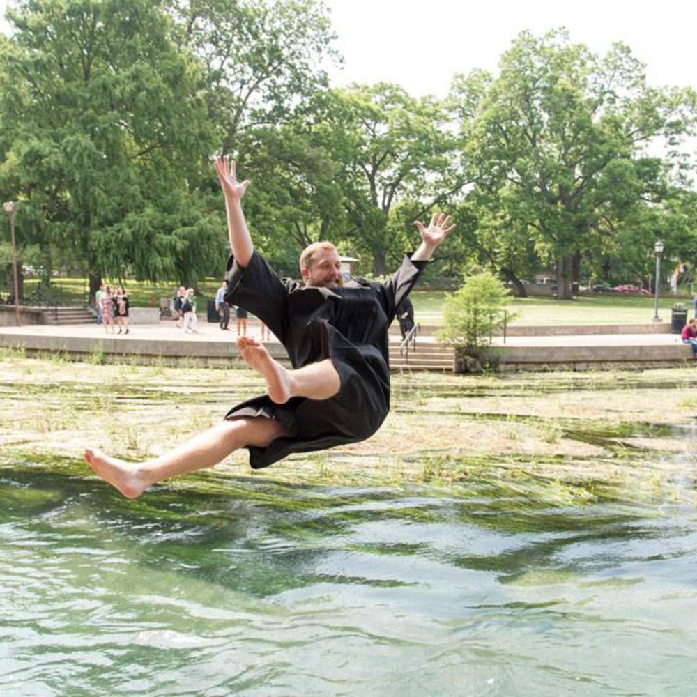 graduate flying backwards into the river