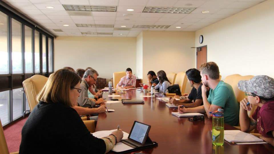 ESC members sitting around a table during a meeting discussing projects