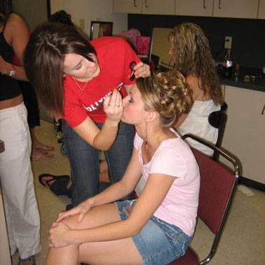 Model having makeup applied before the Fashion Merchandising Fashion Show 2006.