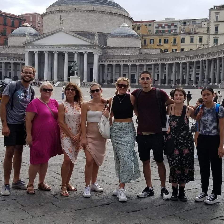group of students and Dr. Di Mauro-Jackson in an Italian city square