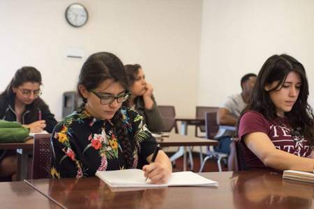students in a Latinx studies class diligently take notes
