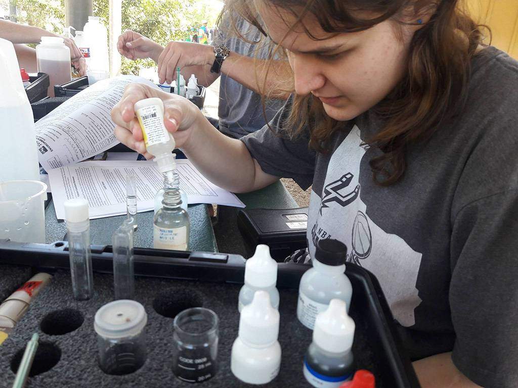 young female testing water quality