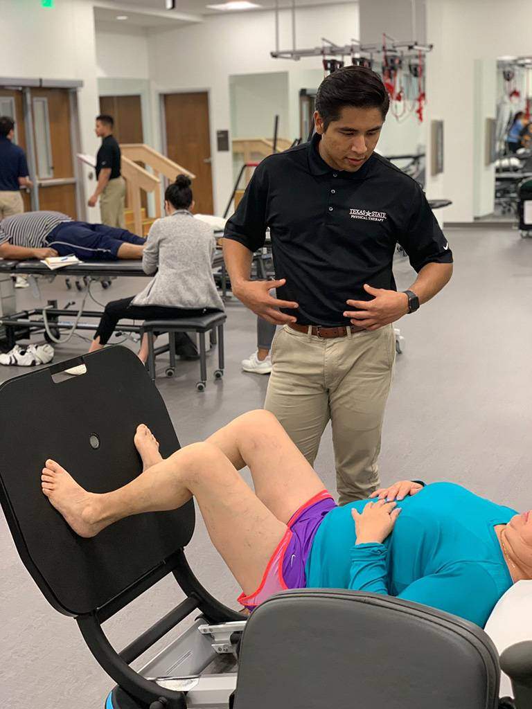 physical therapist helping woman with exercise