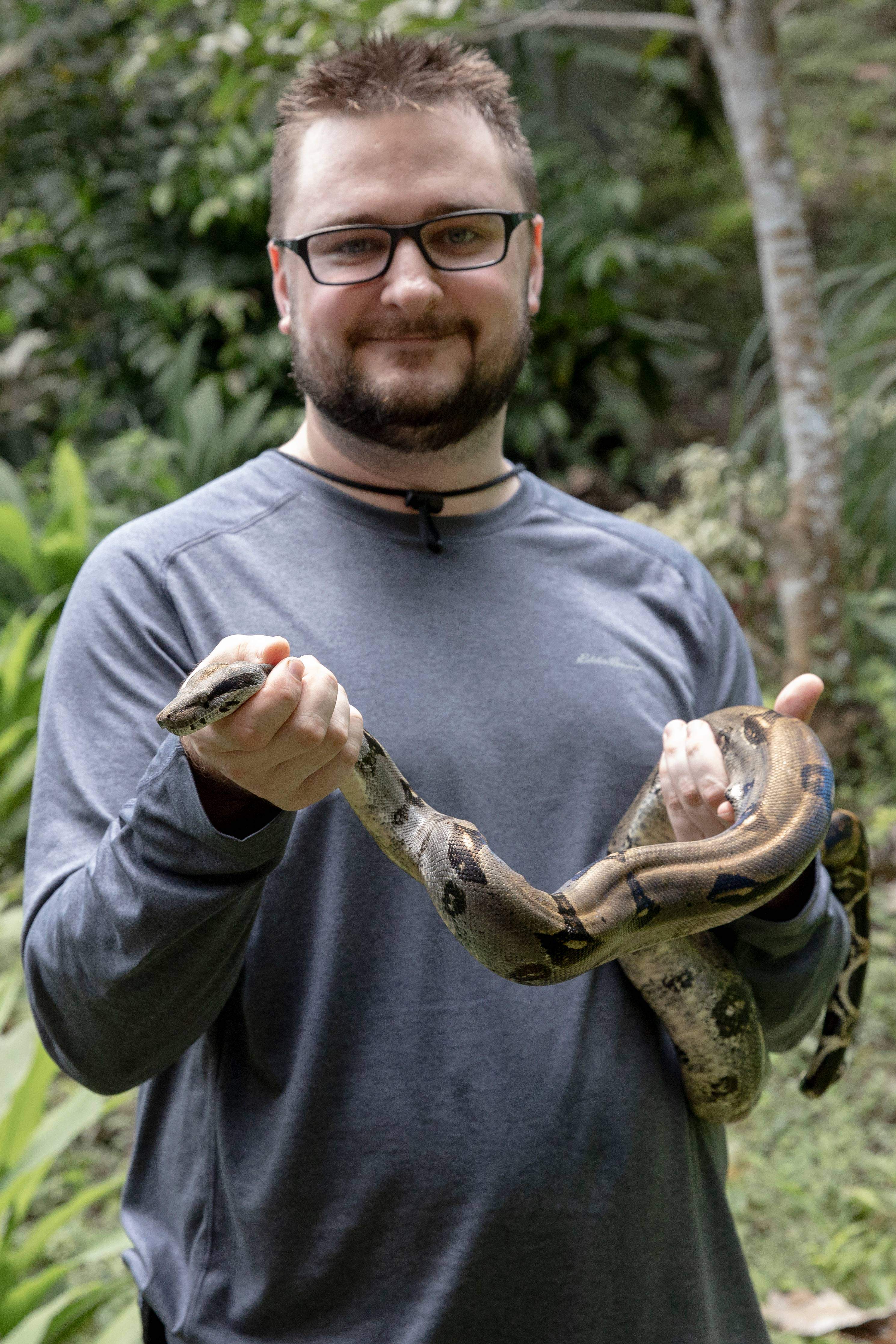 Student Austin Banks holds a boa constrictor