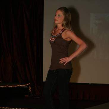 Student wearing beaded tank-top, jeans and high-heels at the fashion show.
