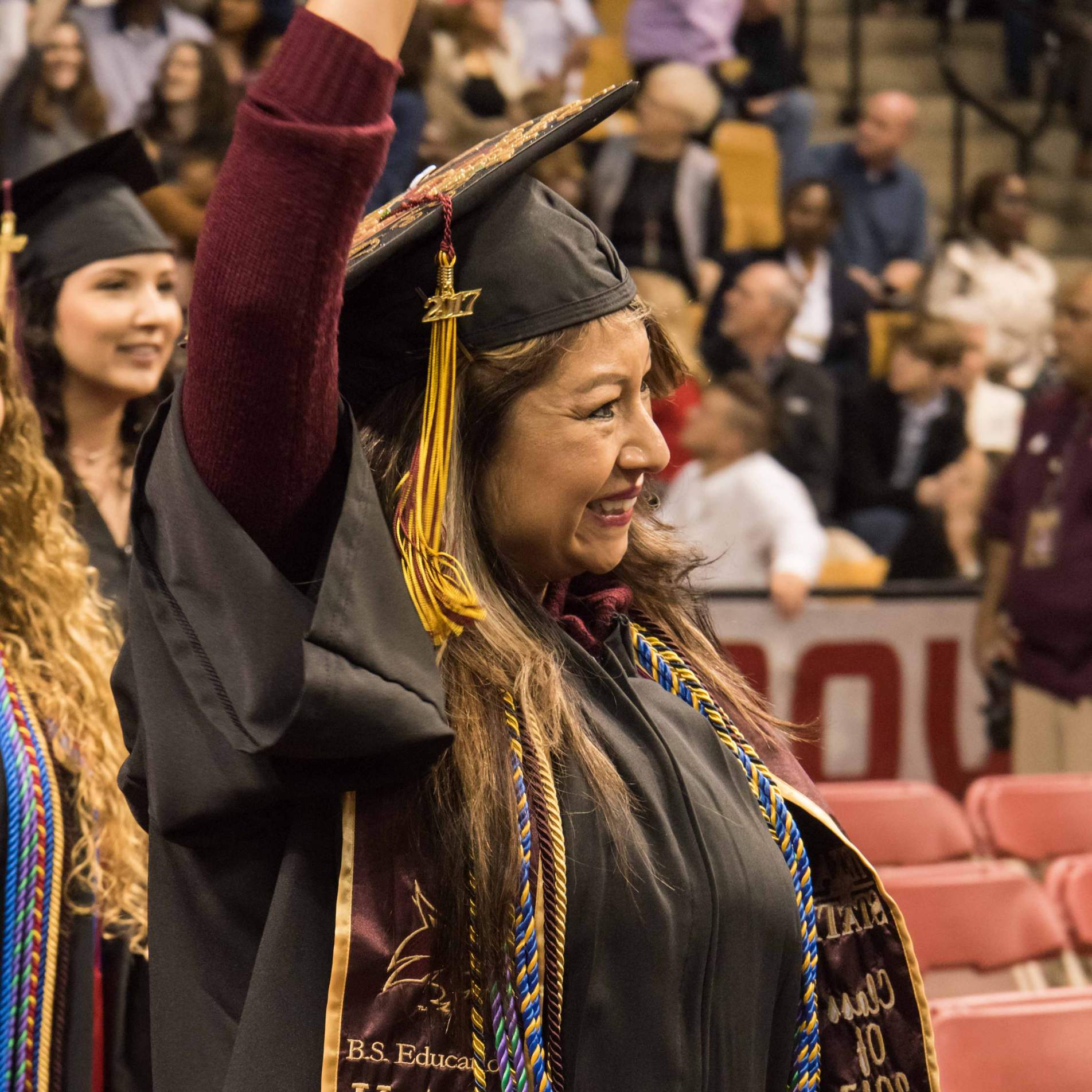 Graduate waving during the processional.