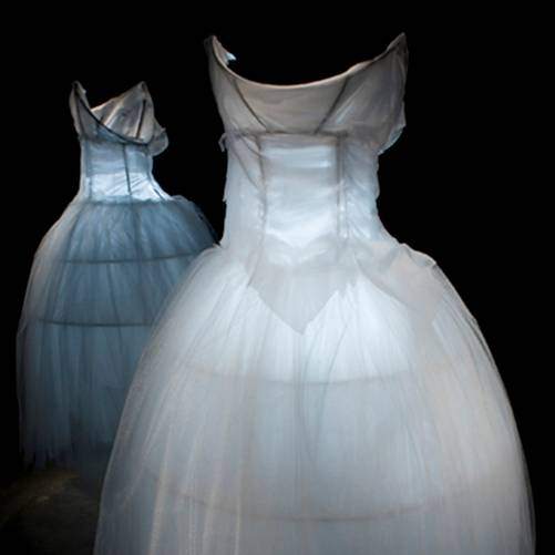 Student work: two transluscent white gowns with glowing light inside