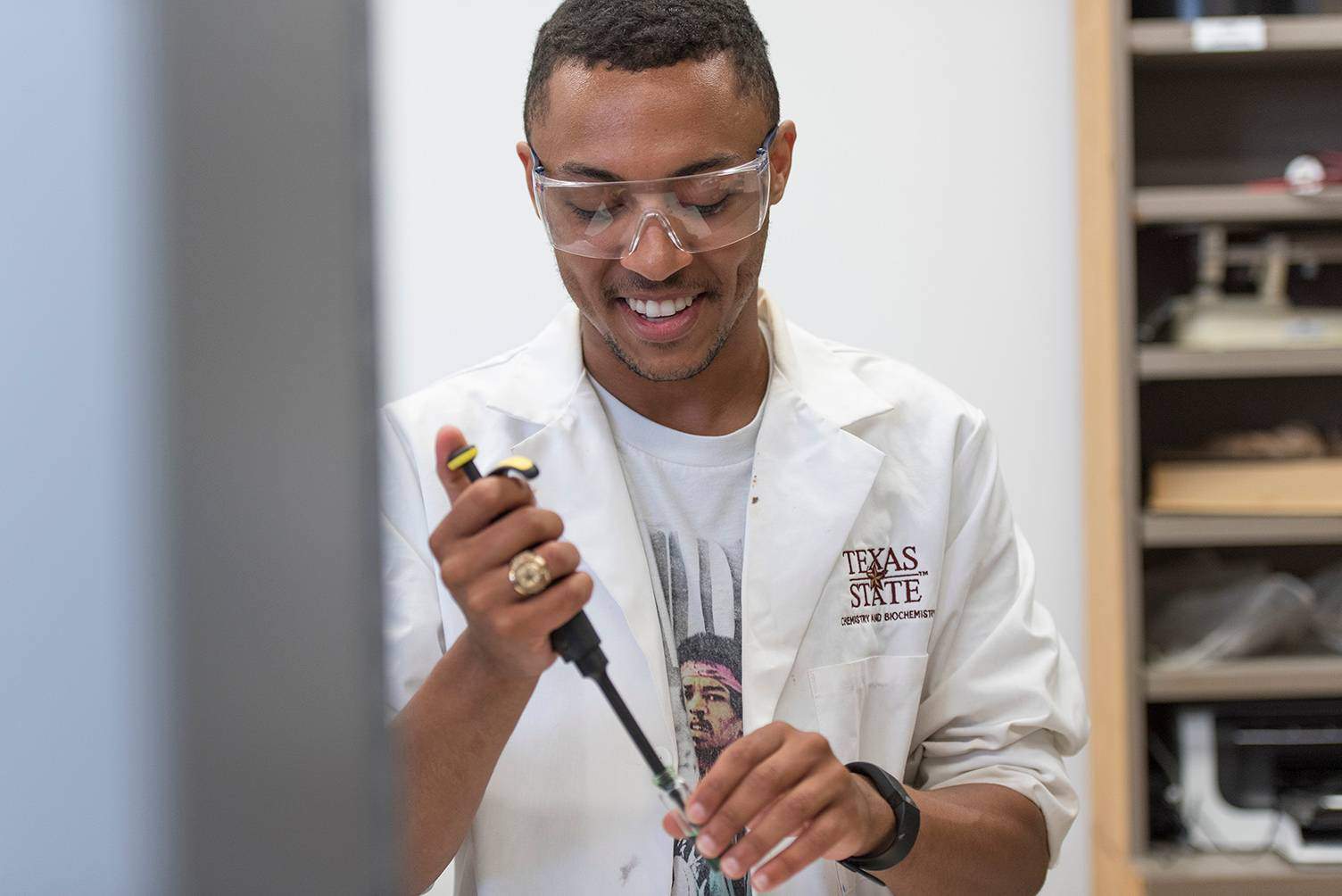 male student filling test tube