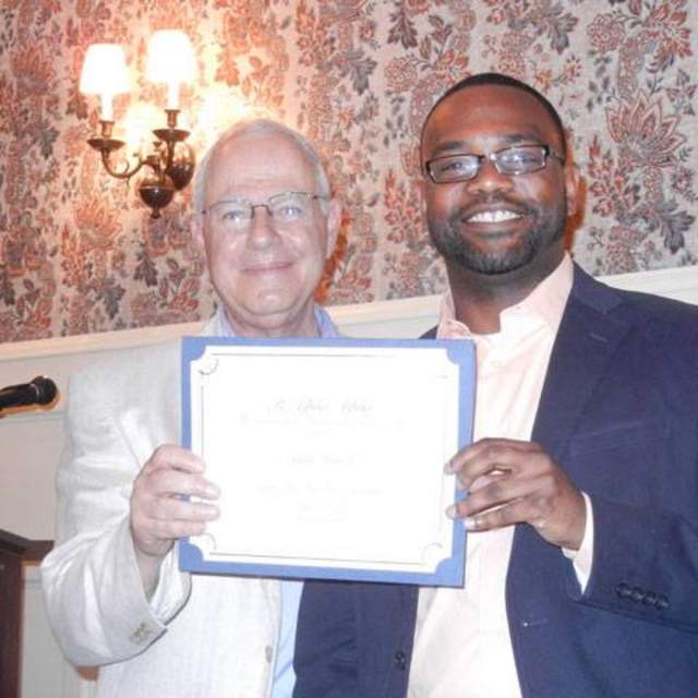 Texas State MPA Student Jamar Keaton (right) receives a certificate recognizing his induction into Pi Alpha Alpha, the National Honor Society for Public Policy & Administration.