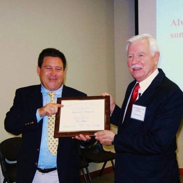 Andrew Hobby presenting Dr. Howard Prince with an honorary CPM Certification