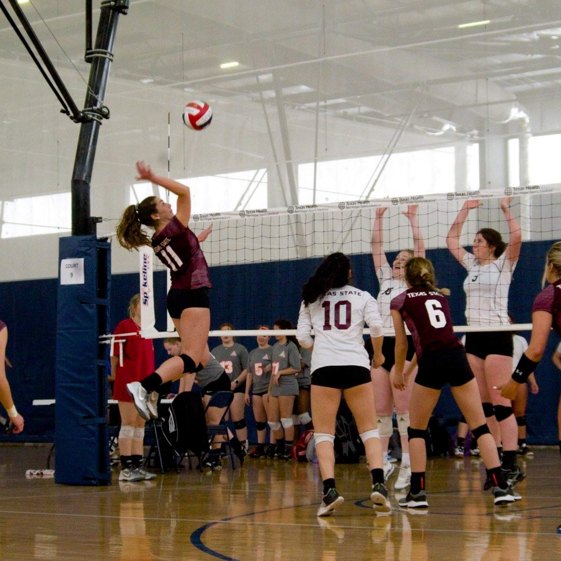 Women's Volleyball player attempts a spike
